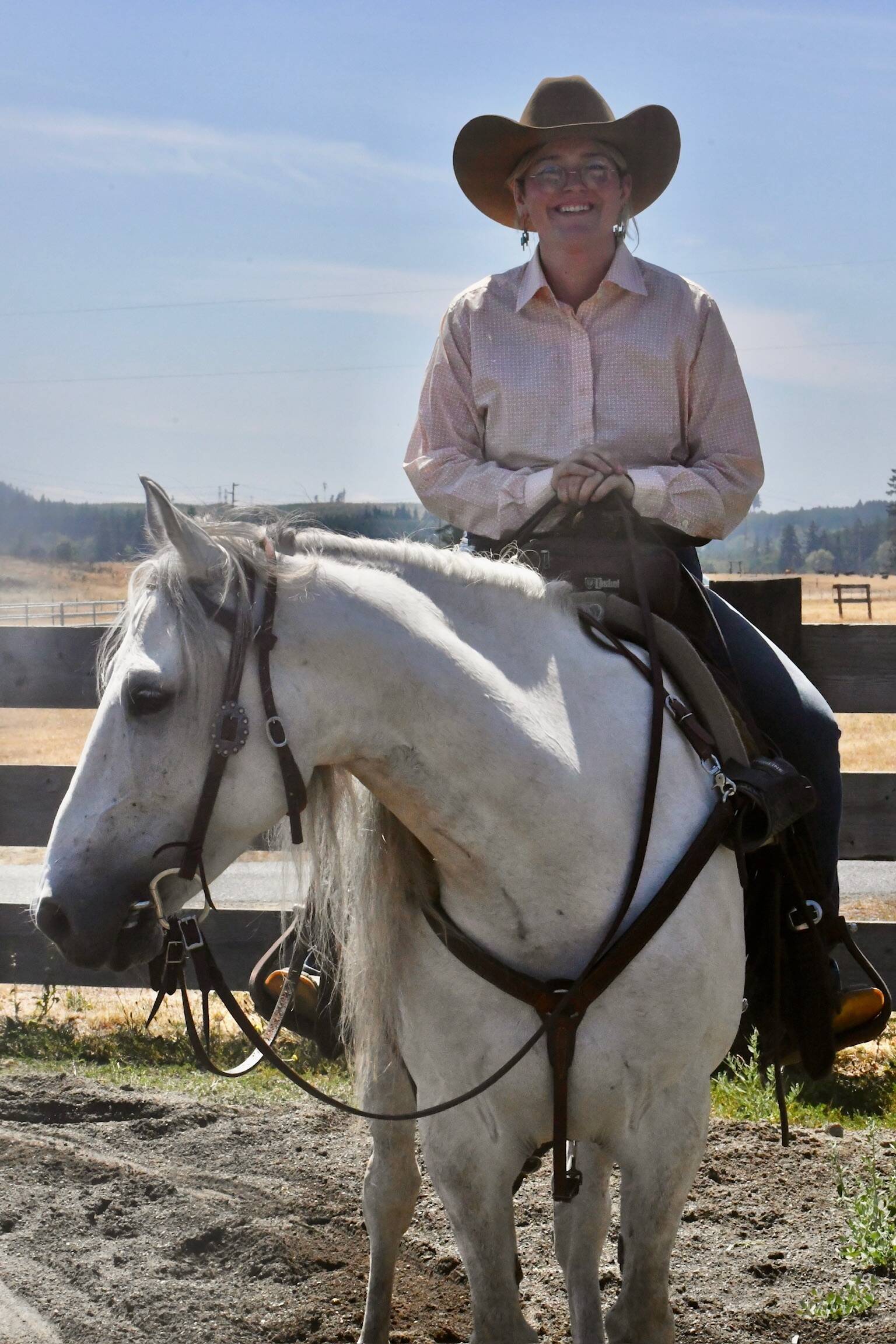 A working western horse and a smiling rider